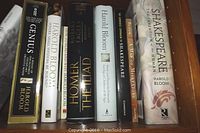 Spine and front cover details of hardcover and paperback books including Harold Bloom's works and Shakespeare texts.