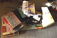 Stack of various board games including Password New York Edition, Trouble, Strategy Poker, Monopoly, and others.