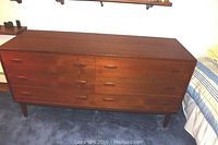 Full front view of dresser showing overall shape, finish, and leg style.