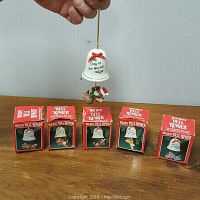 Photo showing all five bell ringer ornaments with original red boxes lined up.