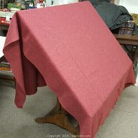 Full view of the wool blanket spread over a chair, showing its size and texture.