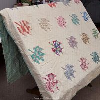 Maple leaf patch quilt draped showing leaf pattern and cream background