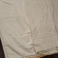Close-up photo showing one folded cream-colored wool blanket with a smooth weave and no visible damage.