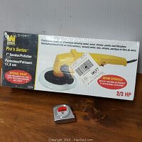 WEN Pro's Series 7 inch sander polisher in box, showing product name and features, along with a tape measure for scale.
