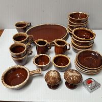 Full lot of brown glazed Hull Oven Proof USA ceramic dinnerware including platters, bowls, cups, creamers, sugar bowls, and salt and pepper shakers.