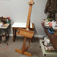 Front angle view of the wooden art easel showing its height and tray.