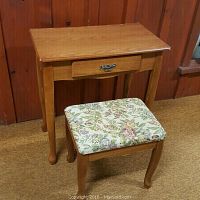 Front view of wooden vanity makeup stand and floral upholstered stool, showing shape and style.