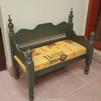 Wooden entryway bench with yellow patterned cushioned seat and turned legs with finials