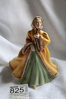 Front three-quarter view showing full figure, coat and dress colors