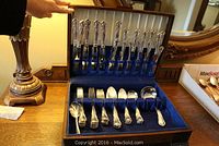 Full set of Haddon Plate silverplate flatware displayed in blue velvet-lined wooden canteen. Handles are etched with floral patterns. Includes multiple forks, spoons, and knives.