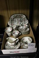 Tea set shown arranged in box with sweets plate at back, six cups and saucers, cream pitcher with saucer, and sugar bowl with saucer at front