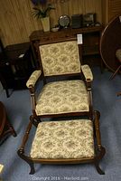 Wood framed East Lake style chair with carved wheat details and upholstered seat, back, and arms; matching floral fabric.