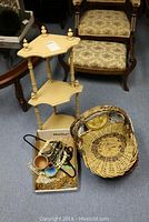 First photo showing wicker baskets and bead necklaces on floor next to wooden corner shelf, with upholstered chairs in background