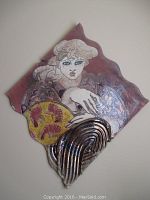 Front view showing the figure's face, shoulders, and upper torso in muted colors with metallic silver detail at bottom.