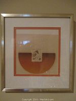 Photo of smaller framed etching showing full artwork with metallic frame and dual matting in off-white and orange