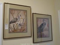 Two framed and matted bird prints signed D. Good, each 13.5x16.5 inches, featuring herons or similar birds in natural settings.