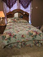 Double bed fully made up with floral linens showing overall bed size and appearance.