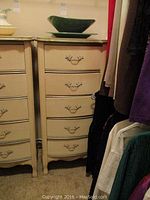 Full view of the wooden chest of five drawers with decorative green platter and bowl on top