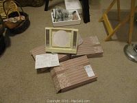 Three Avon makeup mirrors, one unboxed with instruction sheet and two unopened boxed sets with decorative brown and beige packaging.