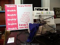 Full view of Simplicity Easy Lock 803 serging sewing machine with box and foot pedal on table.