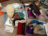 Photo showing styrofoam head with beaded headpiece, assorted small boxes, metal hair clip, hand purse, and metal tray with other beauty items