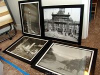 Four framed and matted black and white historic Denver posters arranged on carpet, showing variety of Denver landmarks and street scenes.