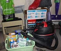Overview of cleaning supplies including Shop-Vac, aerosol sprays, and cat litter box
