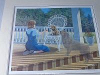 Full view of the framed print showing a girl feeding a puppy on a porch with a dog watching.