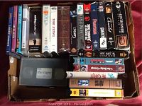 Photo showing a collection of VHS tapes and DVDs, including The Sting, Jurassic Park, Aliens, Braveheart, The Lord of the Rings, and The Crow.