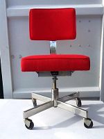 Front view of red upholstered midcentury office chair with chrome base and casters