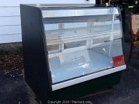 Front angled view showing glass curved front and interior wire shelves.