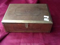 Front-top view showing engraved ship scene on brass lid with hasp clasp and wood sides.