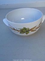 White ceramic bowl with botanical design showing hops and barley motifs, side view
