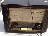 Front view of the vintage Grundig radio showing speaker grille, tuning knobs, push buttons, and brand name.