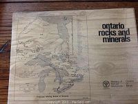 Wooden box lid showing printed map of principal mining areas in Ontario with title 'Ontario Rocks and Minerals' and Ministry of Natural Resources logo.