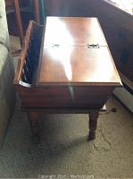 Side view of the drop leaf occasional table showing the wooden legs, drop leaf top and built-in shelf with folk painting detail.