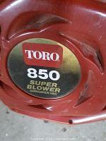 Close-up image of red Toro 850 Super Blower shredder-vac leaf blower label.