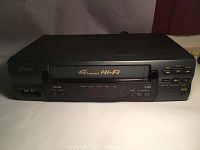 Front view of SV2000 VCR showing cassette slot with 4 Head Hi-Fi stereo labeling and control buttons on right side.