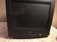 Front view of the Dell E551c CRT color monitor, showing curved screen, brand logo, and control buttons.