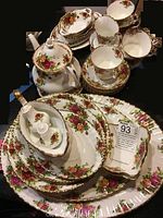 Full set of Duchess Old Country Roses china pieces displayed together including plates, cups, teapot, and serving dishes showing floral pattern and gold trim.