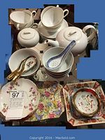 Photo showing white porcelain teapot, teacups, sugar bowl, blue and white soup bowls with spoon, floral square plate, decorative dragon bowls and plates.