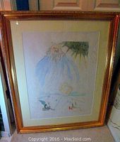 Overall view of framed lithograph in gold frame with cream mat leaning against a door.