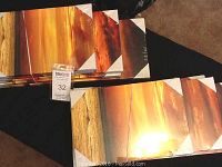 Two identical sets of ocean sunset canvas art collages stacked and wrapped in original packaging
