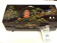 Top exterior view showing the painted oriental themed design with pagoda, trees, and mountain