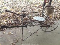 Wire garden cart planter and two wire plant stands showing rust and structural details