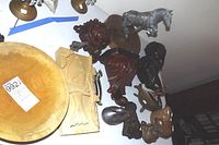Overview of multiple carved wooden corbels, sheep heads, wooden bowl, and some plaster pieces.