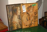 Two framed vintage-style portrait prints side by side on a table, each marked 11x15 inches.