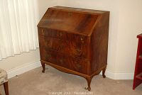 Front angled view of mahogany veneer drop-front secretary desk