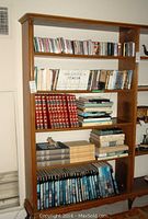 Full bookshelf view showing CDs, books, DVDs across five shelves