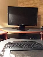 Full view of 15-inch Asus monitor on desk with keyboard in foreground
